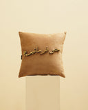 A contemporary cushion accentuates the modern décor of this Lahore-inspired living space.