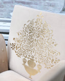 Detailed view of a stylish chair showcasing its refined contours and craftsmanship, placed beside decor elements in a cozy room setting.