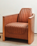 A stylish upholstered chair with sleek legs placed on a patterned rug.