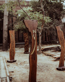 This wooden sculpture enhances the room’s ambiance with its intricate design and rich, natural finish.