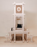 Side view of swing, handmade in Lahore, showing elegant design and soft seating in a relaxed space.