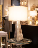 A stylish lamp adds warm light and charm to this elegant living room, enhancing the cozy and inviting atmosphere.