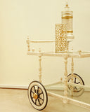 The Haveli Tea Trolley, crafted in Lahore, brings timeless charm to this elegant living room setting.
