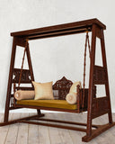 Comfortable indoor swing with decorative cushions, handmade in Lahore, adding elegance and warmth to a stylish living room.