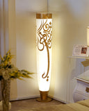 Elegant uplighter with warm glow, handmade in Lahore, adding soft lighting and a cozy feel to a sophisticated living room.