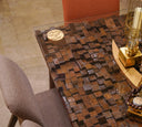Close-up of the dining table surface with neatly arranged tableware and decor accents.