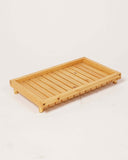 The KK Wooden Tray adds rustic charm to a stylish living room, showcasing exquisite handmade home decor from Lahore, Pakistan.