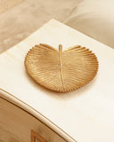 A beautifully crafted leaf-shaped tray adds natural elegance and charm to this stylish living room, handmade in Lahore.