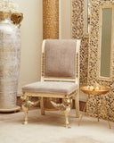 A cohesive living space featuring a stylish chair, accented with decor elements like 2 carved frames, a fibre tray, an uplighter, and an exotic terracotta.