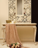 A sleek console table styled with a decorative frame, adding depth and elegance to a modern living room corner.