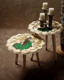 A vibrant hand-painted table featuring a peacock design, adding color and elegance to this stylish living room, crafted in Lahore.