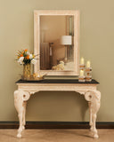 An elegant console and matching frame add timeless style and warmth to this sophisticated living room, handmade in Lahore.