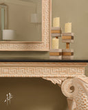 Console table with decorative frame enhances the classic decor and functionality of this refined space.