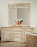 Rivaj Bed Set with dresser in frame styled with mirror and soft decor accents.