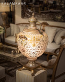 A beautiful lamp brightens this elegant living room, adding warmth and style with intricate design from Lahore.
