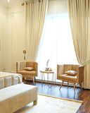 Chair set placed near bed set, styled with cushions to complement the room’s cozy look.