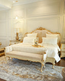 Elegant bed set, handmade in Lahore, shown in a modern room with layered pillows and decorative cushions.