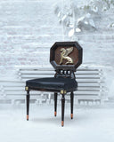 A modern accent chair adds character to a stylish interior, featuring sleek lines and a unique silhouette that complements the contemporary setting.