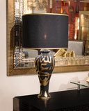 Black lamp placed beside a neutral-toned sofa, enhancing the cozy interior — handmade in Lahore.