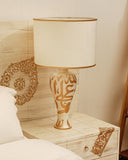 White lamp styled in a minimal setting with natural lighting — handmade in Lahore.