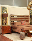 Zaviya bed set in a warm, stylish bedroom styled with rich bedding textures.