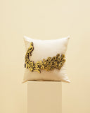 Decorative pillow with 3D peacock design on a beige base.