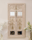 Antique door wall hanging, handmade in Lahore, adding a vintage charm to a stylish living room.

