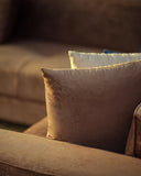 Close-up of brown textured pillows on a sofa with a blurred background