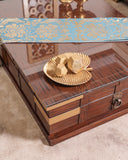 Plush upholstered sofa set with layered cushions and wall art, creating a rich visual experience.

