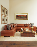 Living room with a brown leather sectional sofa and decorative pillows.