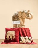 Elegant Rajasthani elephant decor with embroidered cushion and flowers, perfect for home decor and handmade furniture in Pakistan.