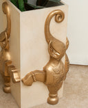 Decorative planter with gold elephant design on a neutral background