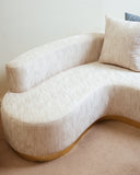 A close-up view of the sofa reveals its refined new fabric, showcasing rich texture and quality craftsmanship.