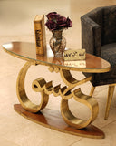 Decorative glass table with gold metal base in a room setting