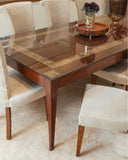 Dining table with glass top and wooden frame in a room setting