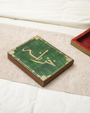 The Khazana Jewelry Box, shown with its lid closed to highlight the detailed artistry on its top, sits gracefully in a luxurious living room adorned with handcrafted décor from Lahore, Pakistan.