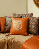 Leatherette KK Embroidered Cushion in a luxurious living room setting, complementing handcrafted furniture from Lahore, Pakistan