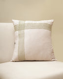 Decorative pillow with geometric pattern on a beige sofa