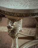 Decorative table with marble top and lion head design on legs