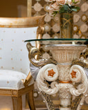 Decorative table with intricate design next to a chair with gold accents.