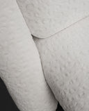 Close-up of textured light white fabric with a subtle pattern