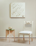 Sheraton Chair with cane accompanied by a coordinating side table, beautifully arranged in a contemporary living space and our khayal panel mother of pearl