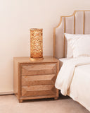 A close-up reveals the lamp’s refined detailing, from its smooth finish to its clean, modern lines.