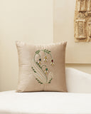 Decorative pillow with floral embroidery on a beige background