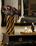 Close-up of dresser next to black Swan Bed Set with minimal accents.

