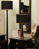 Nightstand lamp beside black Swan Bed Set casting soft ambient light.

