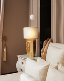 Decorative lamp on a side table next to the swab bed